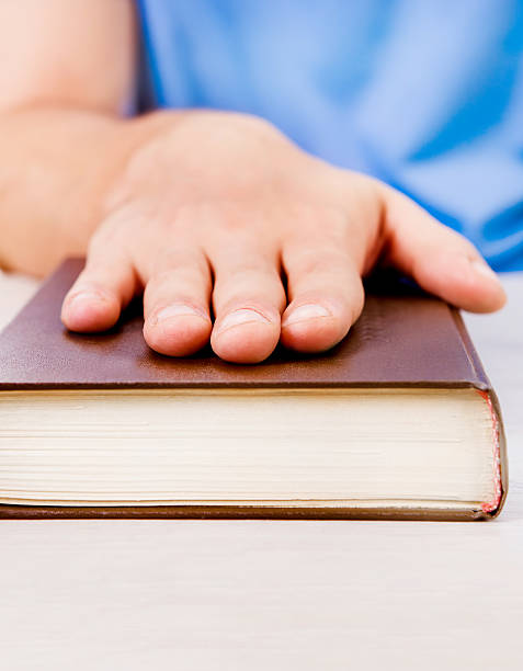 istock Hand on the Book closeup 2248675903