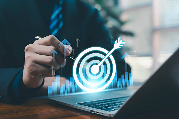 istock A glowing target icon with an arrow above a laptop represents business goal setting, strategy planning, performance improvement, digital growth, and corporate success for modern organizations. 2248676015