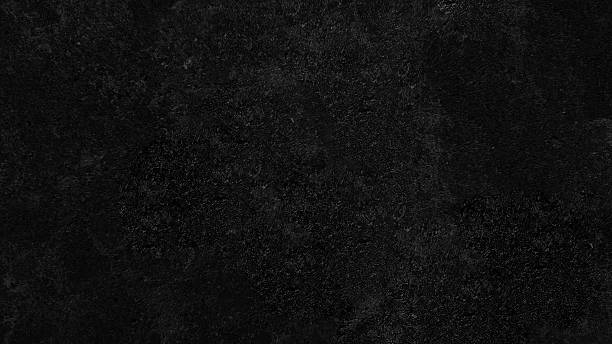 istock A dark, textured abstract background with a grainy, speckled surface resembling a close-up of a rough material. 2248676084