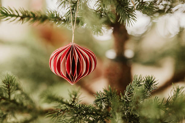 Christmas ornament bauble close up hanging in tree low key