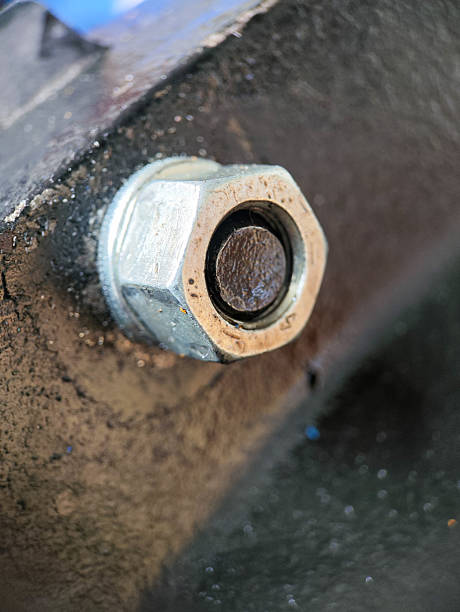 istock tight-fitting metal hex nut secured onto a bolt head. 2248680451