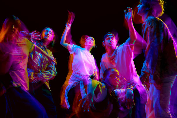 istock Neon light dancers captured in artistic motion blur 2248681215