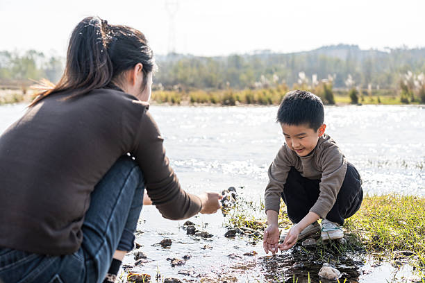 istock A woman and a little boy playing by the river 2248682511