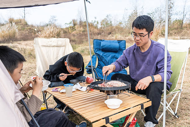 istock Outdoor camping scene with people having a barbecue 2248682573