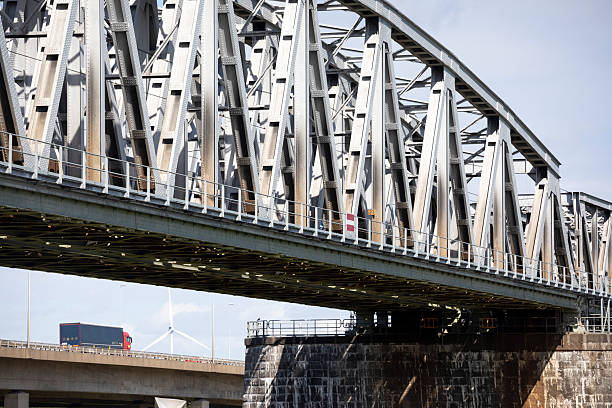 Railway bridge over the Waal River near Zaltbommel, Netherlands. The lorry is on the A2 motorway.