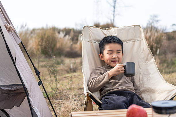 istock A young boy enjoying a cup of drink while camping outdoors 2248683172
