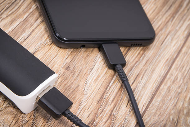 istock External powerbank using to charge empty battery of black smartphone 2248683783