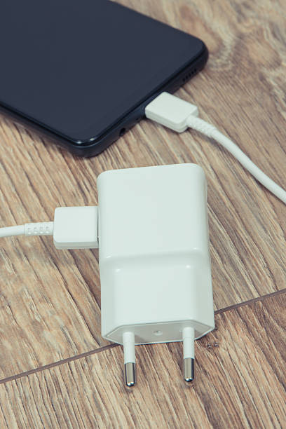 istock Black smartphone and charger using to charge empty battery. Various devices charging concept 2248683799