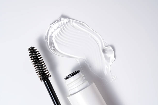 istock transparent eyelash eyebrow or gel serum, with black brush on white background. smooth and shiny texture stroke presentation 2248683975