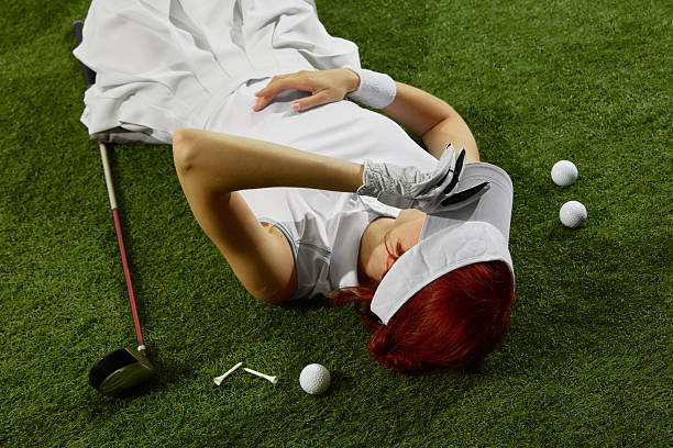 istock Woman lying on golf field with glove and visor 2248684029