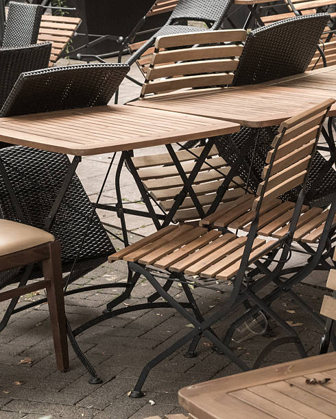 istock Empty outdoor cafe tables and chairs inviting customers 2248685168