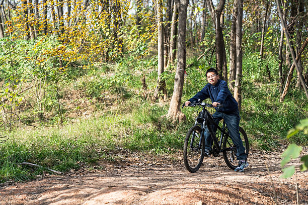 istock Man riding bicycle on a forest trail enjoying outdoor activity 2248685409