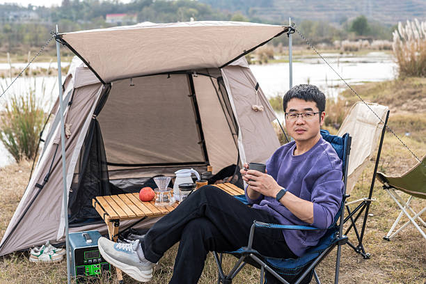 istock A man enjoying camping by a tent near a lake 2248685643