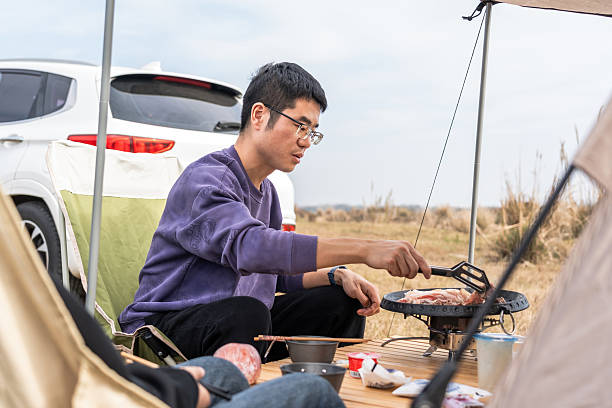istock A man grilling food while camping outdoors 2248685745