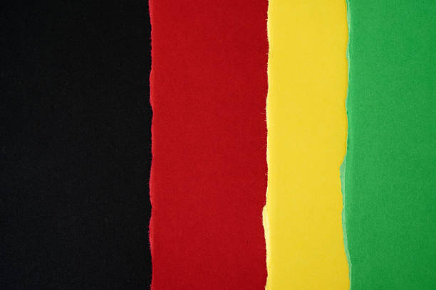 istock background with a torn paper texture in black, red, yellow, and green 2248687932