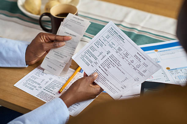 istock Middle Aged Black Woman Calculating Taxes Using Receipts and Financial Documents 2248689987