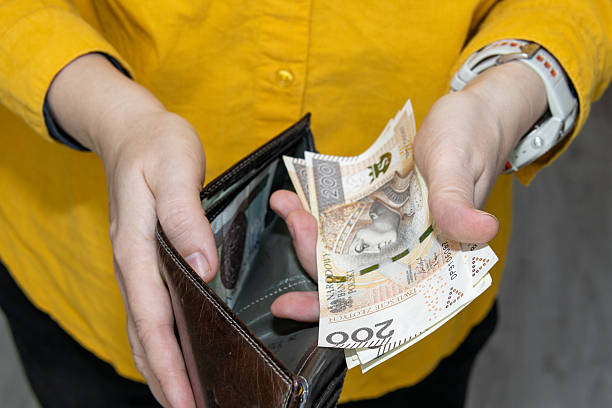 istock Hands taking Polish zloty banknotes from a leather wallet symbolizing cash payment spending and everyday personal finance 2248692024