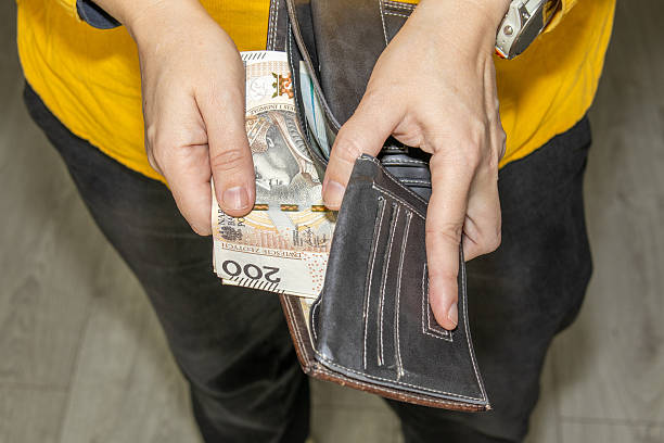 istock Hands taking Polish zloty banknotes from a leather wallet symbolizing spending cash payments personal finance 2248692030