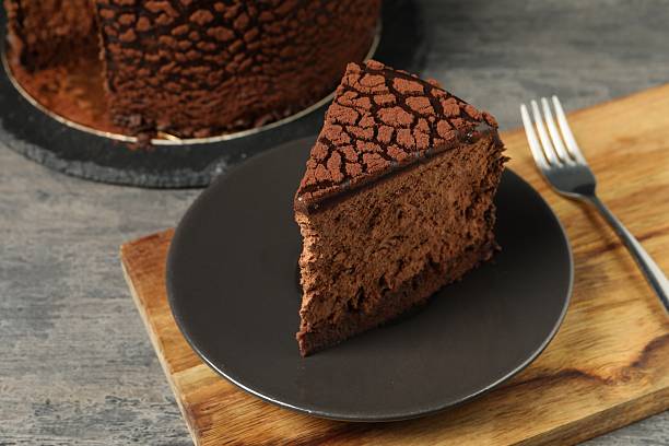 istock Piece of delicious chocolate truffle cake on grey textured table, closeup 2248692053