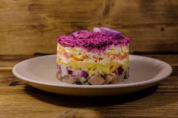 istock Ceramic plate with russian traditional new year salad herring under fur coat (shuba) and on rustic wooden table 2248697983