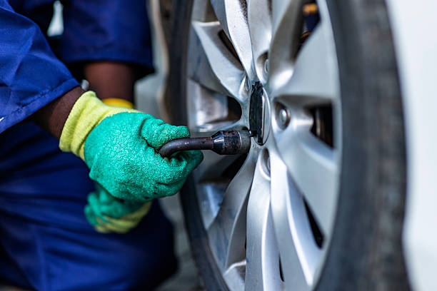 istock Close-up, African mechanic hands changing a car tire in his workshop 2248698162