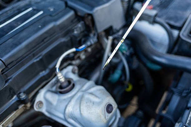 istock Close-up of a car engine dipstick pulled out, showing the oil level 2248699060