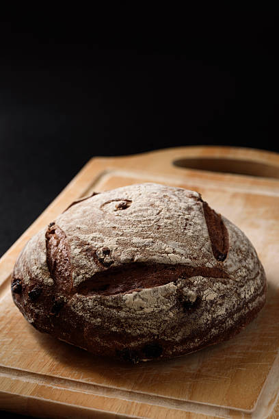 Freshly baked sourdough bread   on a black background