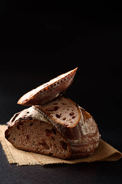 istock Freshly baked sourdough bread   on a black background 2248702154
