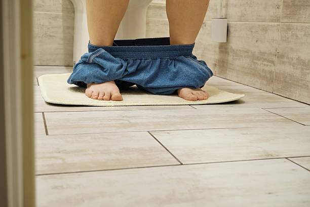 istock Person sitting on toilet with pants down 2248704334