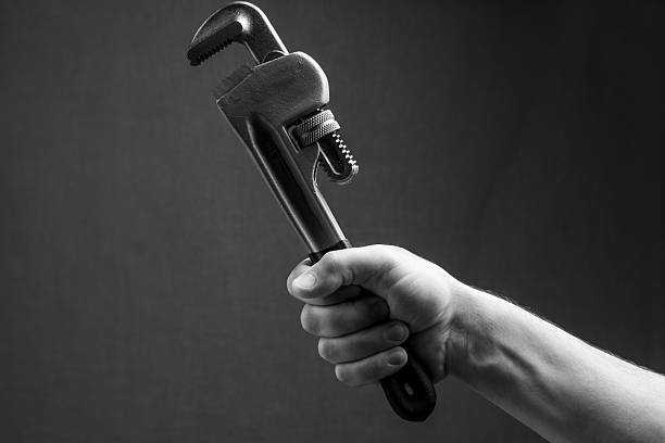 Red adjustable pipe wrench top view isolated