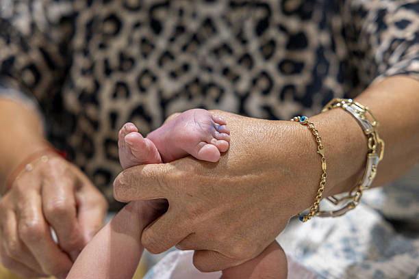 holding newborn baby feet