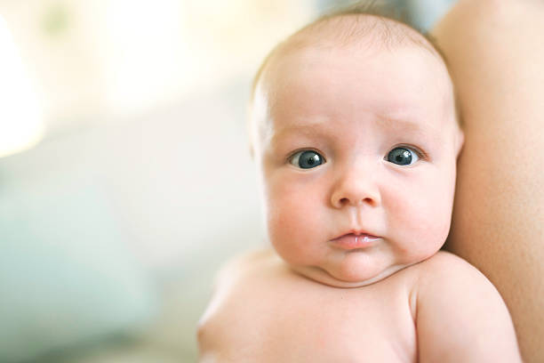 A mother with her newborn baby on knee