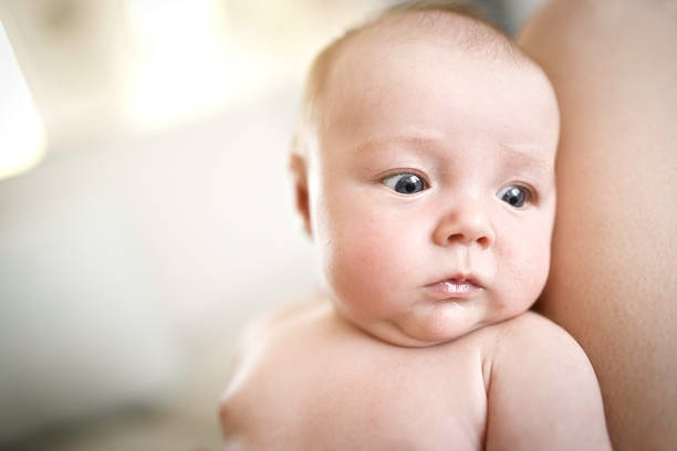 A mother with her newborn baby on knee
