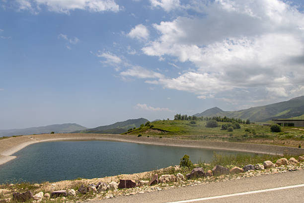 Vehicle crosses the bridge of a large dam in the Picos de Europa, - Riaño - Spain\nCastilla y León