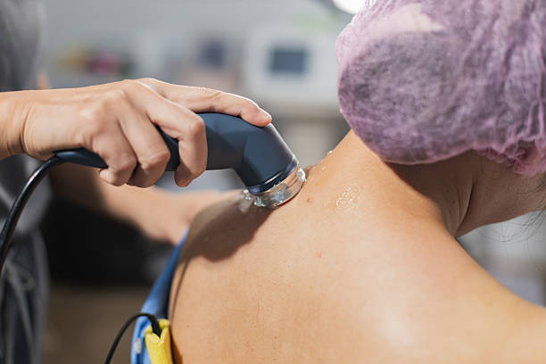 istock Professional physiotherapist performing ultrasound therapy on patient neck representing office syndrome rehabilitation 2248710140