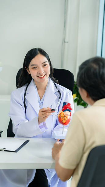 Elderly Asian man visits doctor for consultation about heart disease. In nurse, elderly care concept of heart disease.