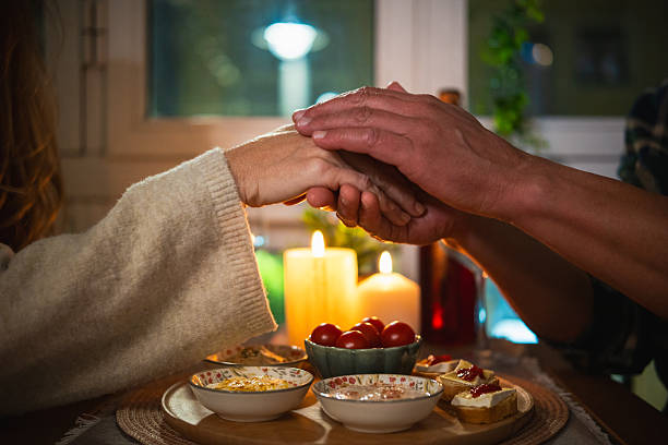 istock Couple holding hands during romantic candlelight dinner 2248712475