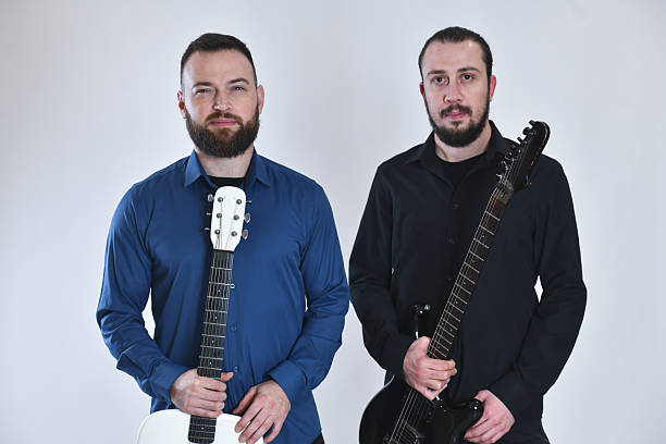istock Two Band Members Pose With Guitars On White Studio Background, Handsome Musicians Look Into Camera 2248714180