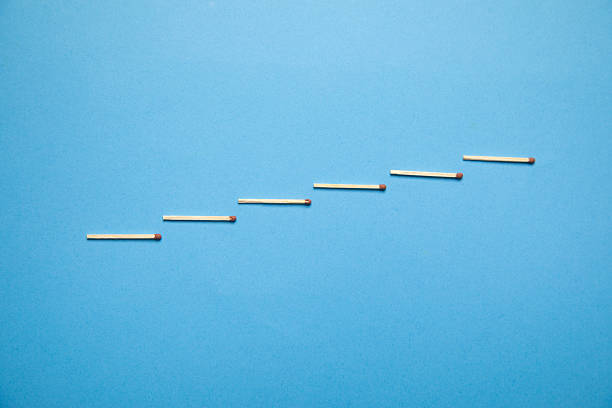 Staircase made by match on the blue background.