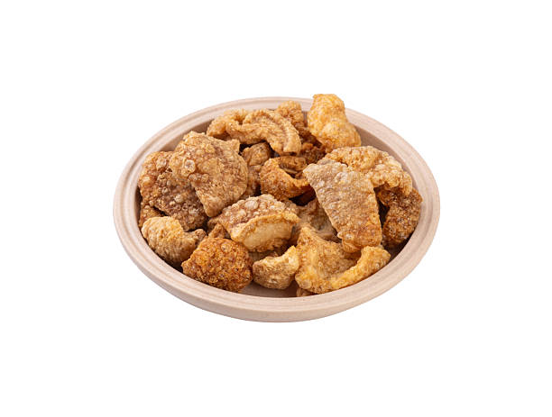 istock Fried pork cracklings on a plate isolated over white background 2248717956