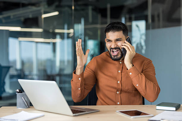 istock Angry businessman yelling during phone call in office 2248718451