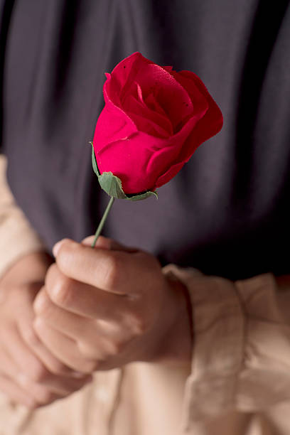 istock Woman Holding a Single Red Rose 2248718941