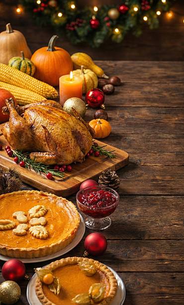 istock Traditional Christmas or Thanksgiving dinner feast with turkey and pumpkin pie. Vertical wooden background with copy space. 2248719184