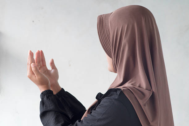 istock Muslim Woman Praying with Raised Hands 2248719339