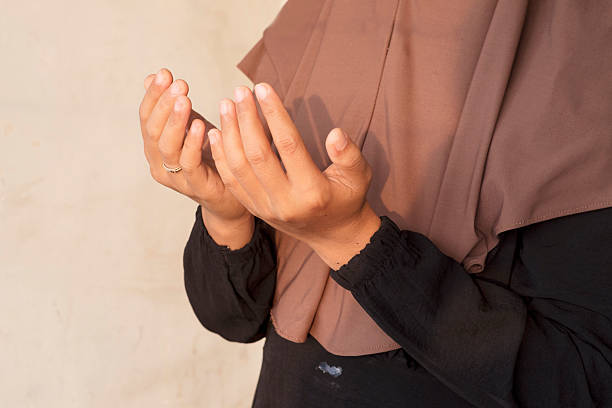 istock Muslim Woman Raising Hands in Prayer 2248719488
