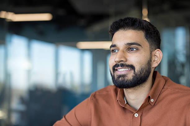 istock Smiling indian business man with beard looking away 2248720712
