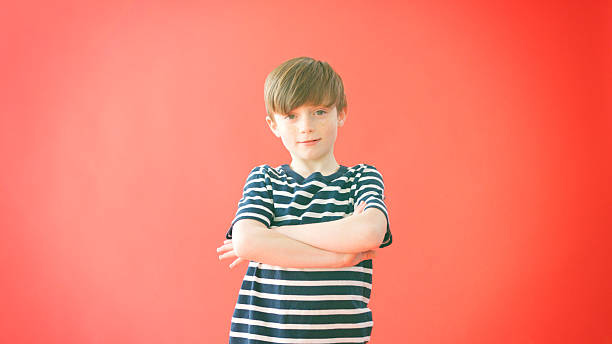 istock Portrait Of Smiling Young Boy Against Red Studio Background 2248721548