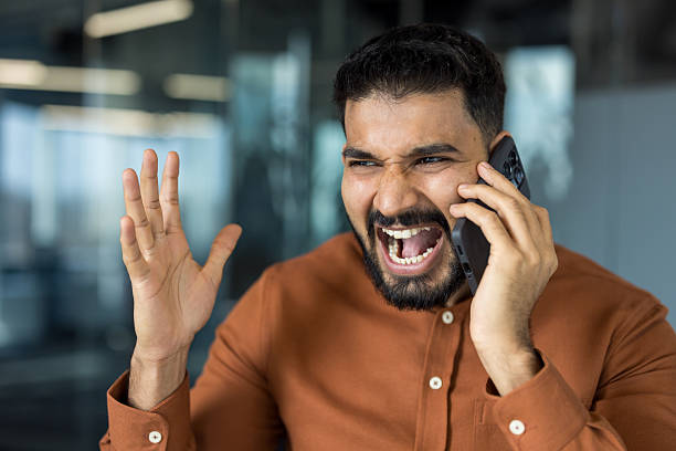 istock Angry indian man yelling during phone call in office 2248721686