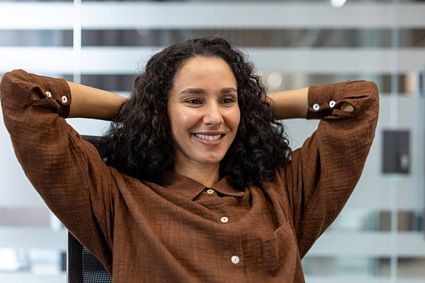 istock Happy woman relaxing at office break, hands behind head 2248725869