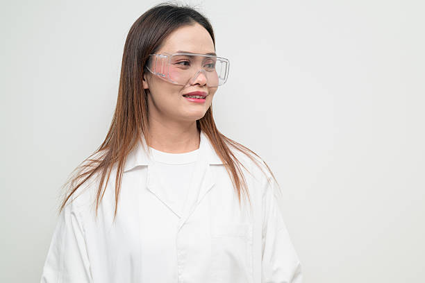 istock Asian Female Scientist in Protective Glasses Thinking Studio Portrait 2248726122